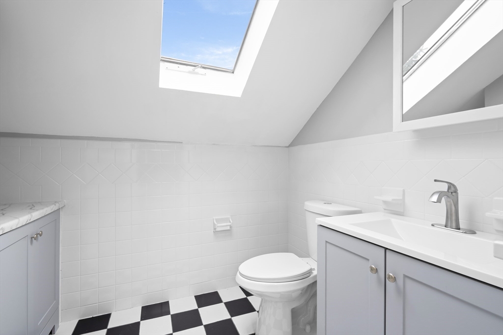 572 William Street Fall River, MA 02721 - Photo 22 of 31 a bathroom with a sink a toilet a window and vanity