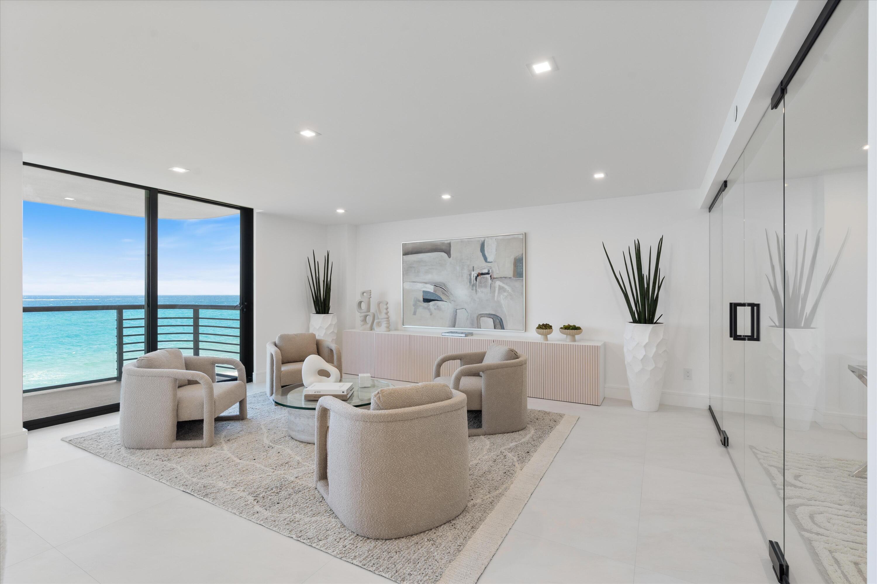 250 South Ocean Boulevard, Unit 3E & 3F Boca Raton, FL 33432 - Photo 11 of 46 a living room with furniture large window and flat screen tv