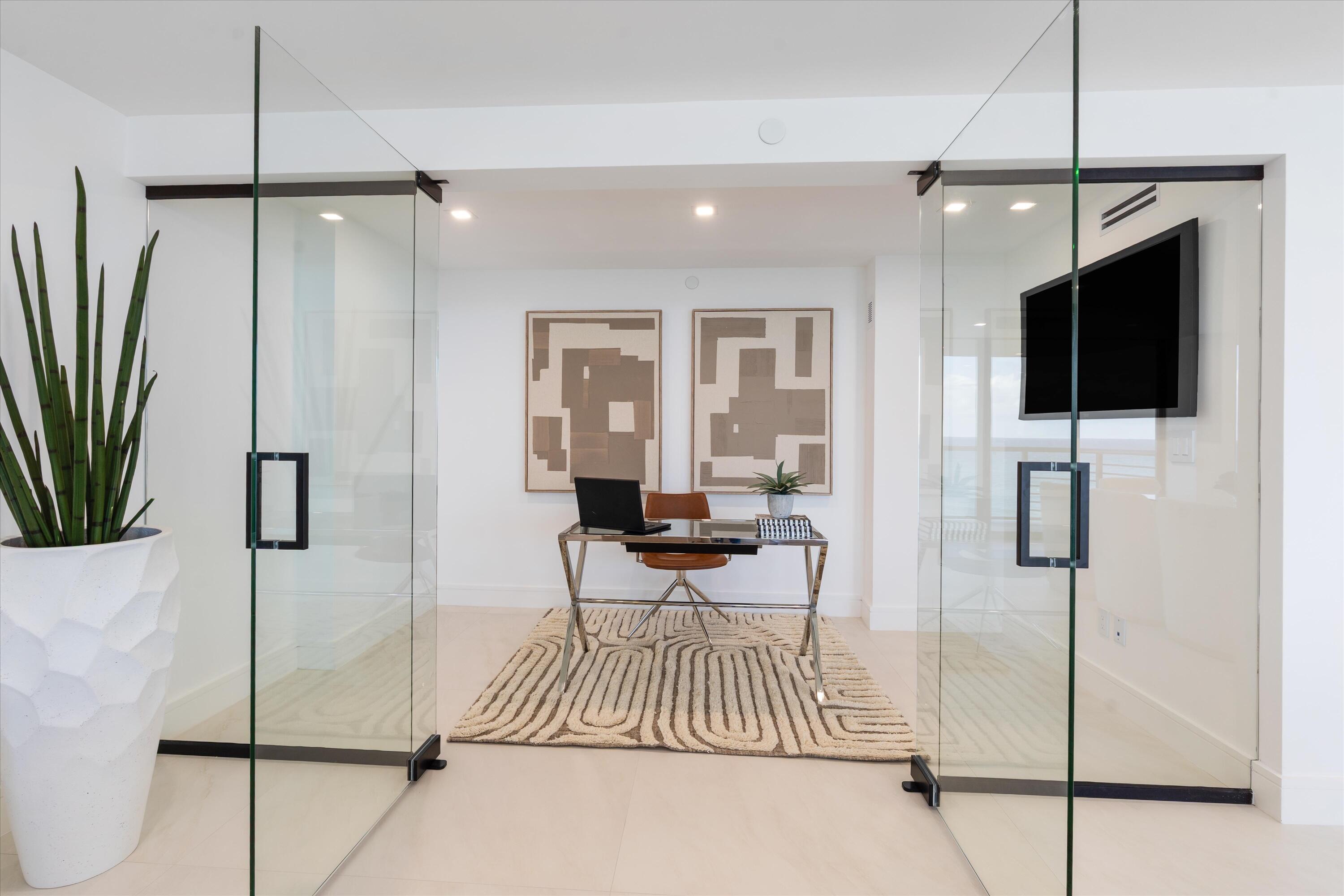 250 South Ocean Boulevard, Unit 3E & 3F Boca Raton, FL 33432 - Photo 14 of 46 a living room with furniture and a flat screen tv