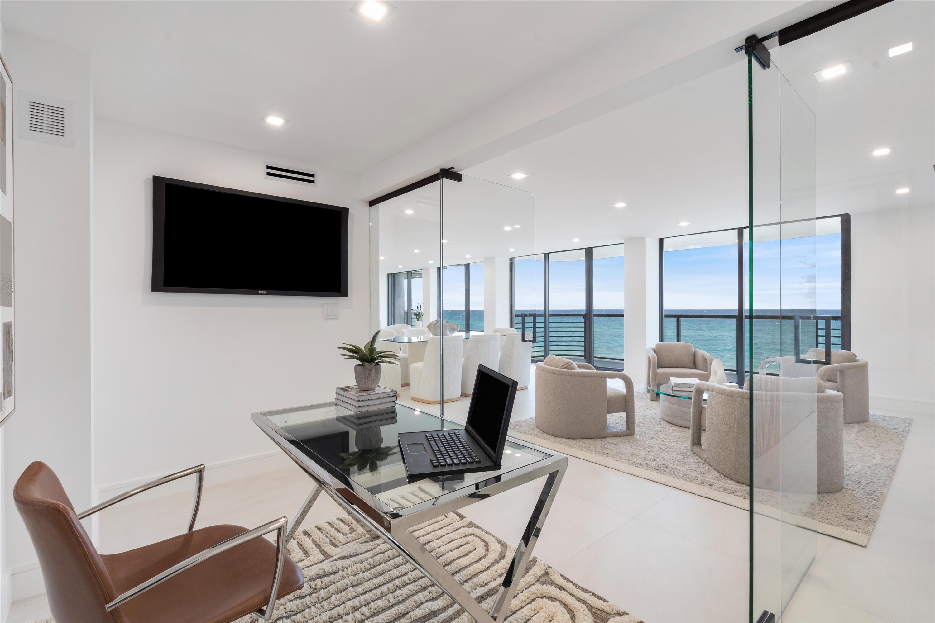 250 South Ocean Boulevard, Unit 3E & 3F Boca Raton, FL 33432 - Photo 15 of 46 a living room with furniture and a flat screen tv