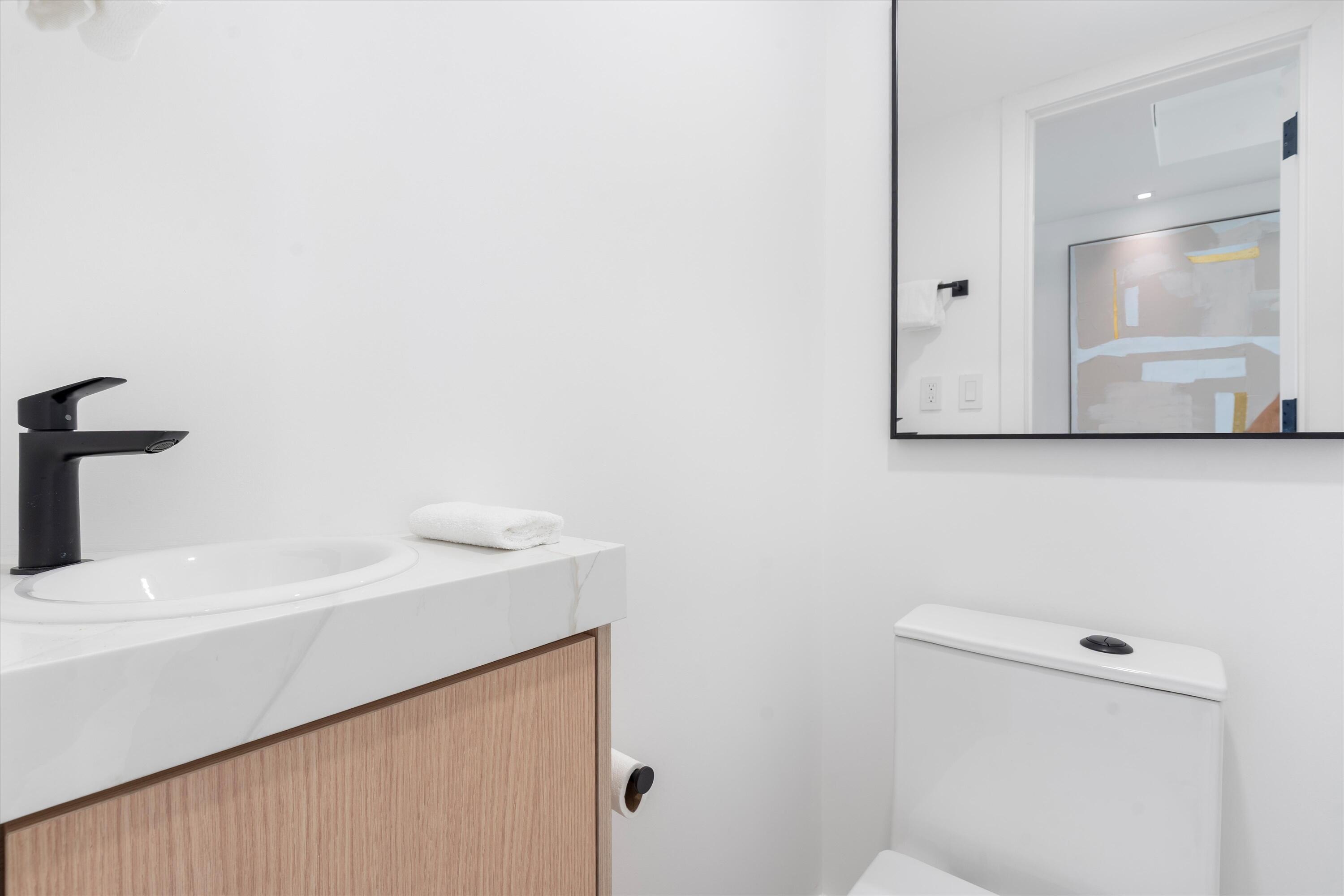 250 South Ocean Boulevard, Unit 3E & 3F Boca Raton, FL 33432 - Photo 16 of 46 a bathroom with a sink and a mirror