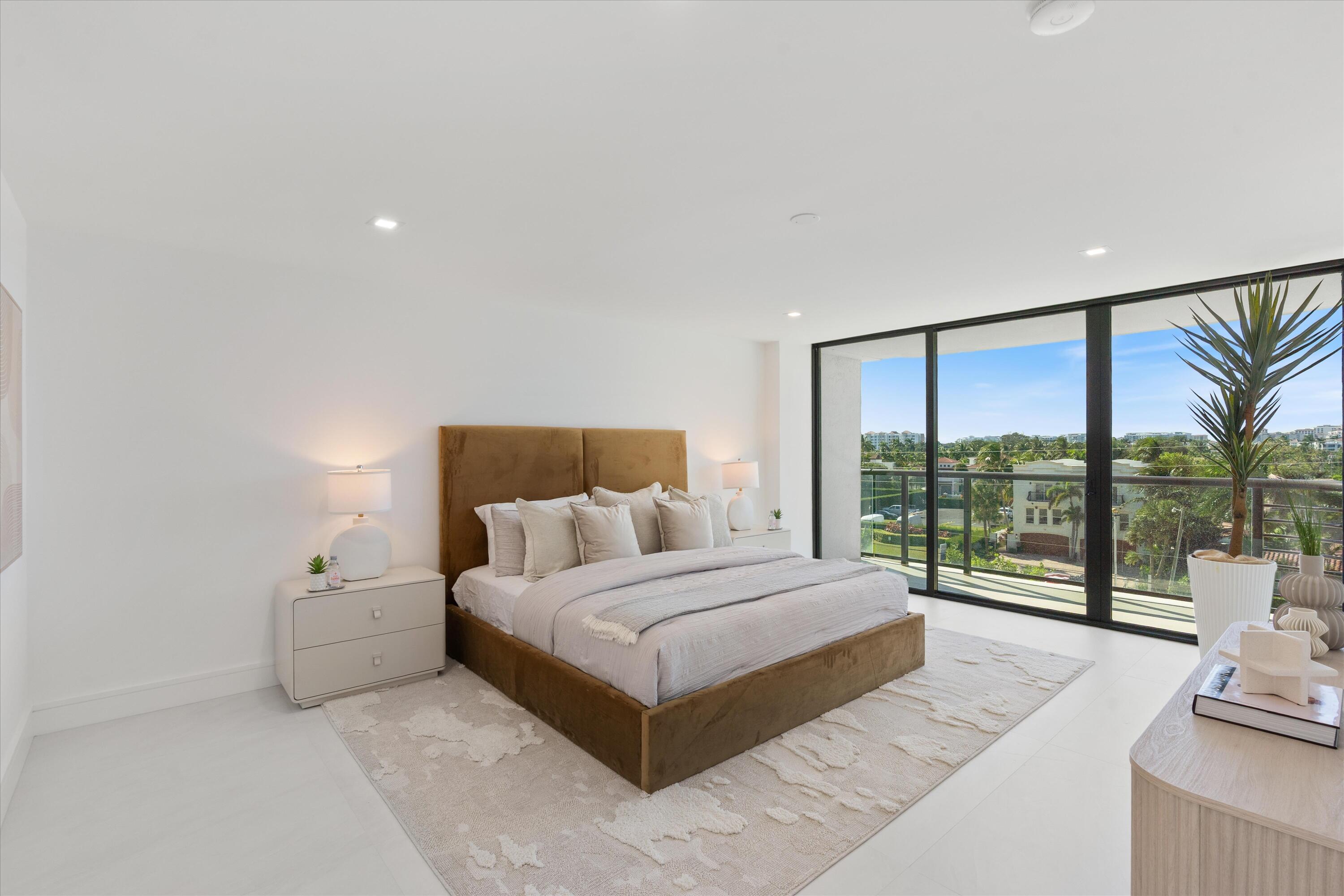 250 South Ocean Boulevard, Unit 3E & 3F Boca Raton, FL 33432 - Photo 17 of 46 a bedroom with a large bed and a large window