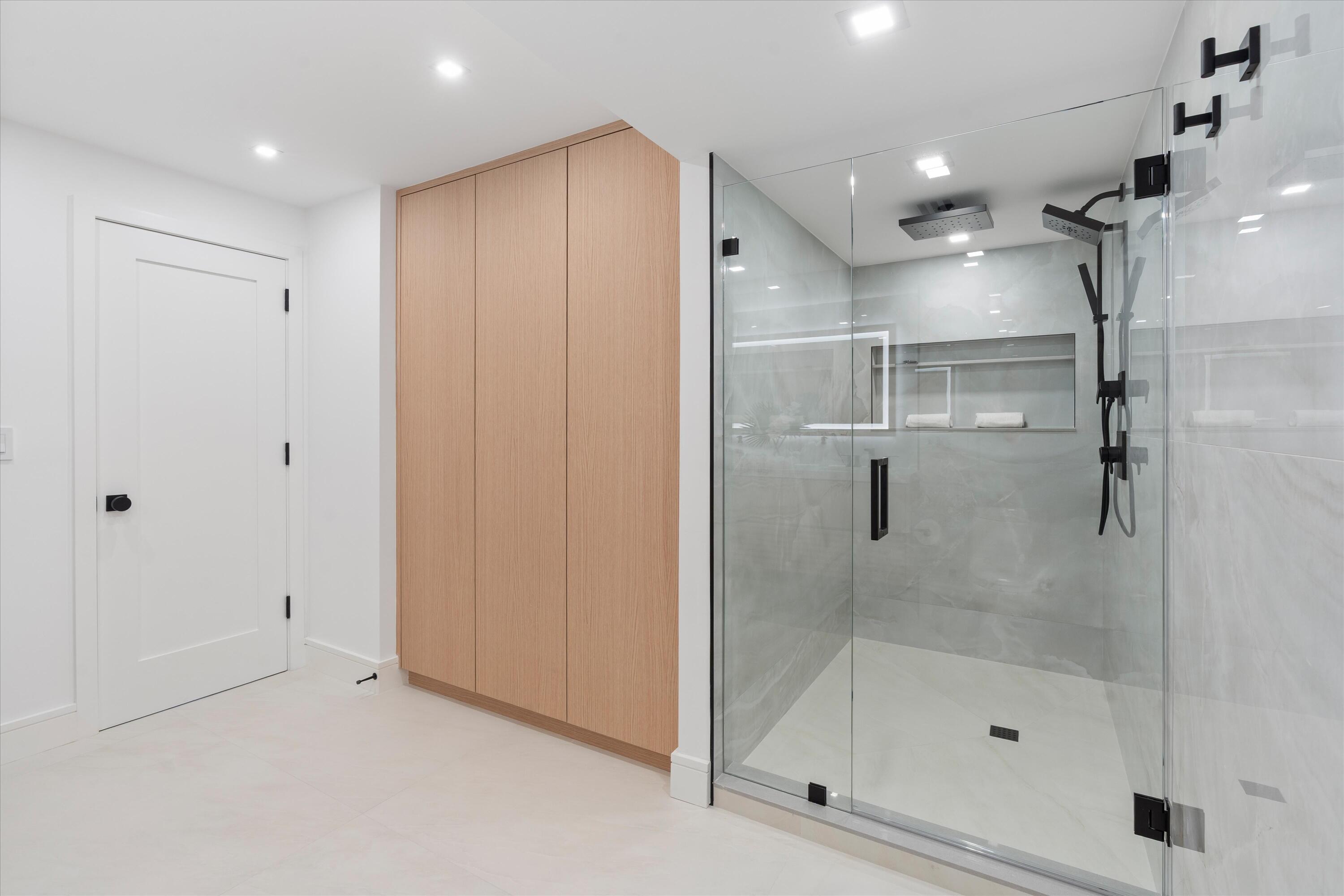 250 South Ocean Boulevard, Unit 3E & 3F Boca Raton, FL 33432 - Photo 20 of 46 a bathroom with a shower and a glass door