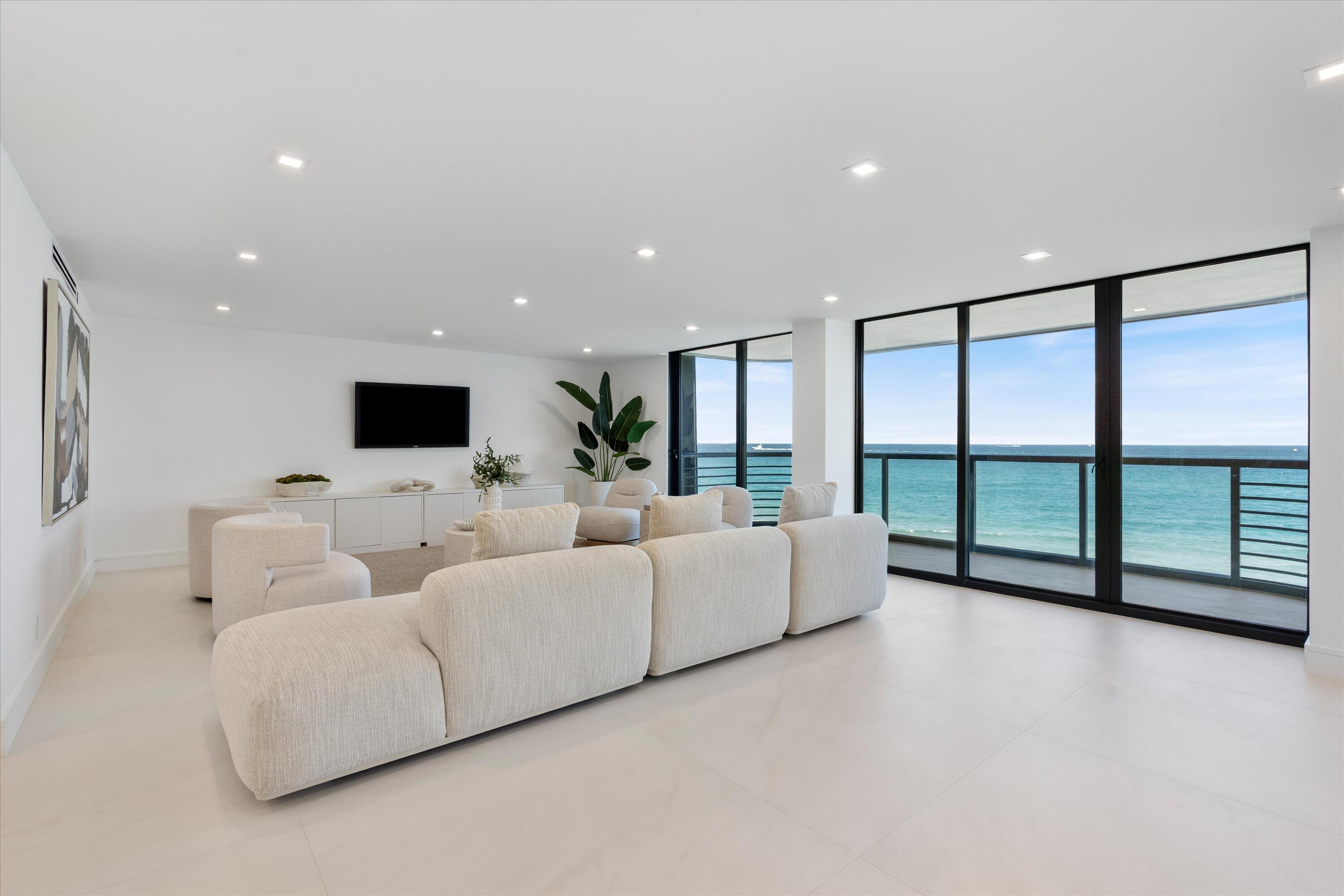 250 South Ocean Boulevard, Unit 3E & 3F Boca Raton, FL 33432 - Photo 2 of 46 a living room with furniture and a flat screen tv