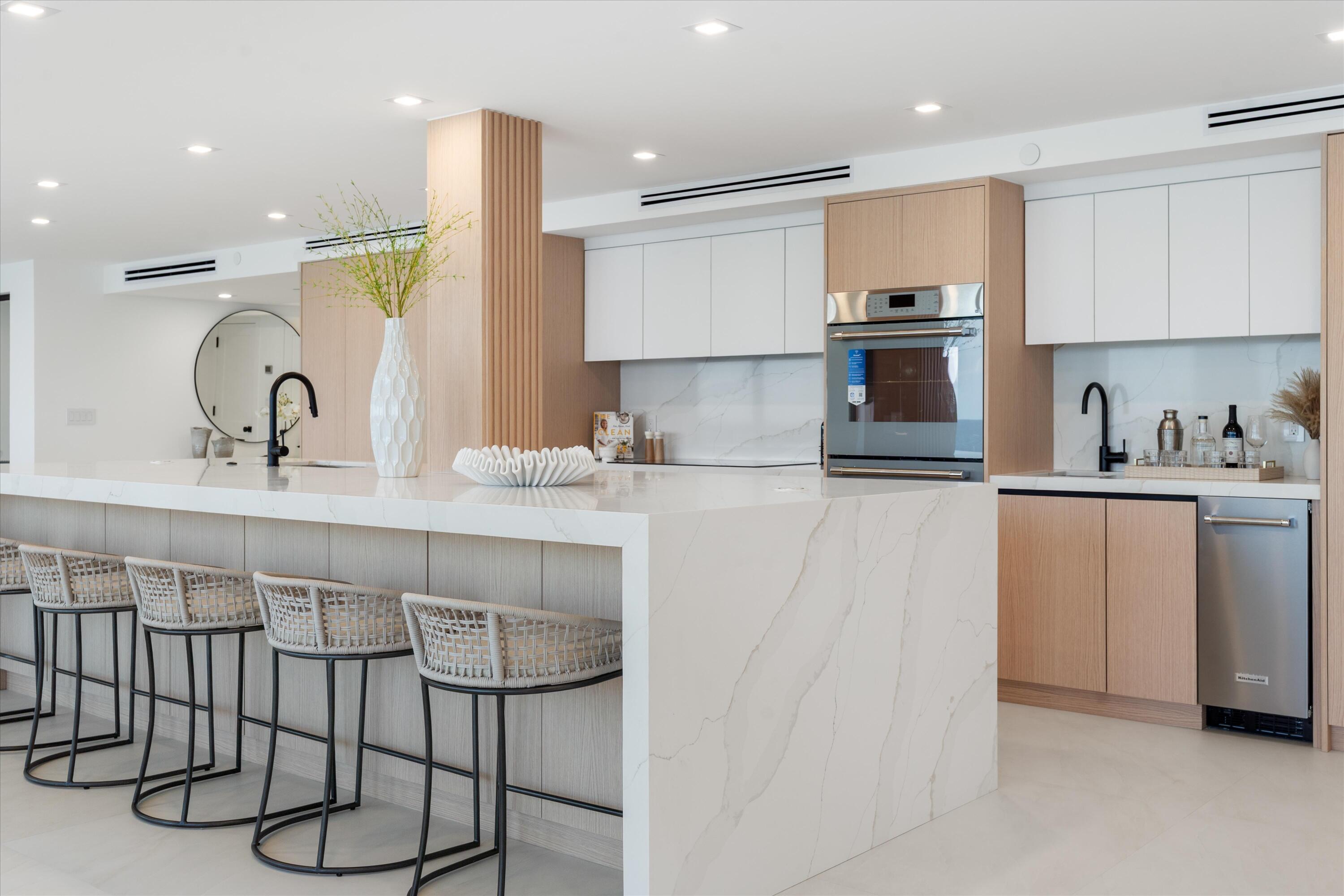 250 South Ocean Boulevard, Unit 3E & 3F Boca Raton, FL 33432 - Photo 6 of 46 a kitchen with kitchen island granite countertop a sink cabinets and window