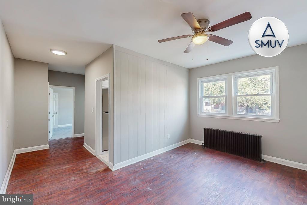 1605 Homestead Street, Unit 1 Baltimore, MD 21218 - Photo 1 of 18 wooden floor in an empty room with a window