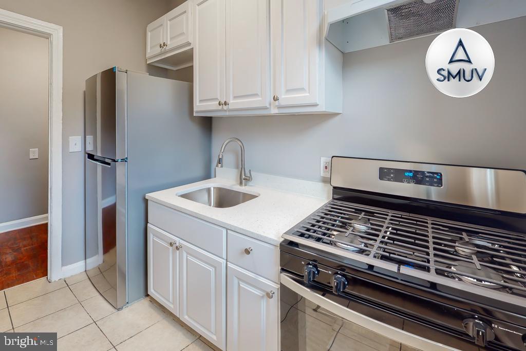1605 Homestead Street, Unit 1 Baltimore, MD 21218 - Photo 15 of 18 a kitchen with a stove and a refrigerator