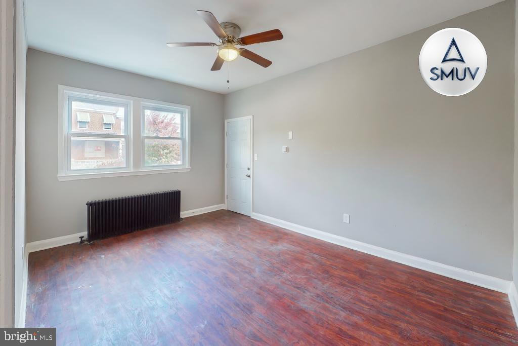 1605 Homestead Street, Unit 1 Baltimore, MD 21218 - Photo 16 of 18 an empty room with wooden floor and a window