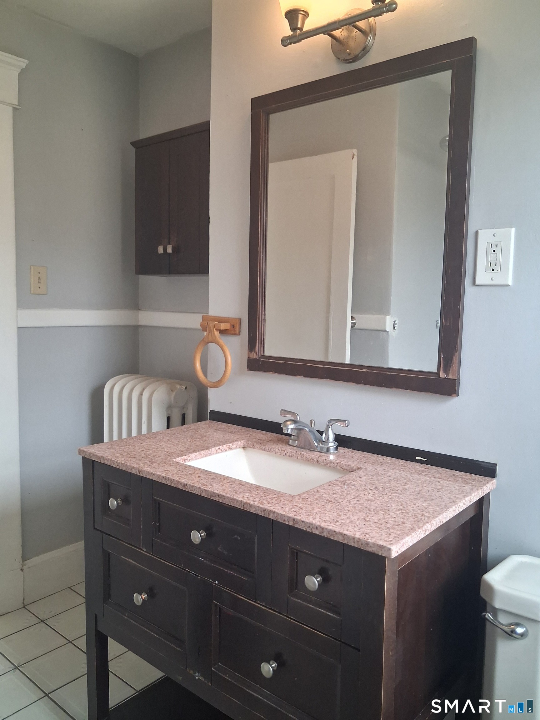 26 4th Street Hamden, CT 06514 - Photo 25 of 40 a bathroom with a granite countertop sink vanity and mirror