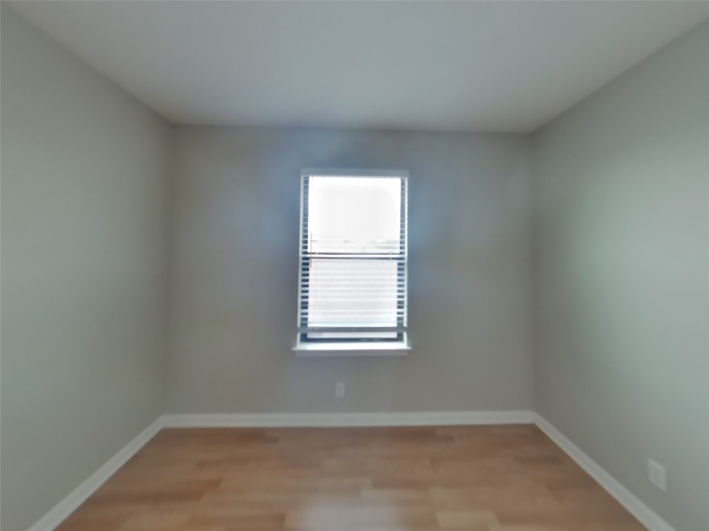 1027 Trail Driver Cove Georgetown, TX 78626 - Photo 10 of 17 Unfurnished room with light wood finished floors and baseboards