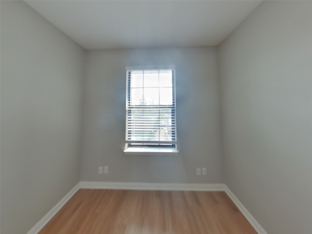 1027 Trail Driver Cove Georgetown, TX 78626 - Photo 13 of 17 Unfurnished room featuring baseboards and light wood finished floors