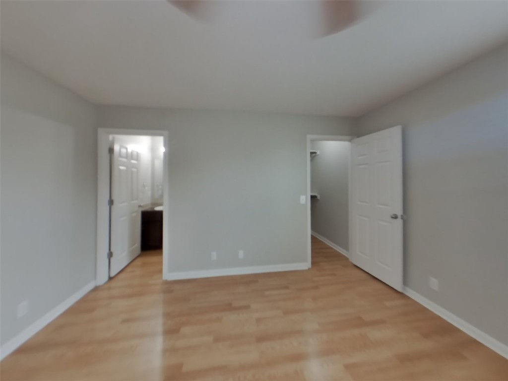 1027 Trail Driver Cove Georgetown, TX 78626 - Photo 5 of 17 Unfurnished bedroom featuring light wood finished floors and ensuite bathroom