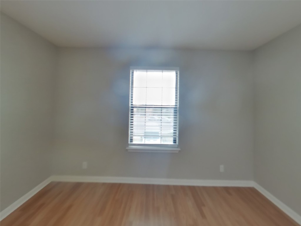 1027 Trail Driver Cove Georgetown, TX 78626 - Photo 8 of 17 Unfurnished room featuring baseboards and light wood-type flooring