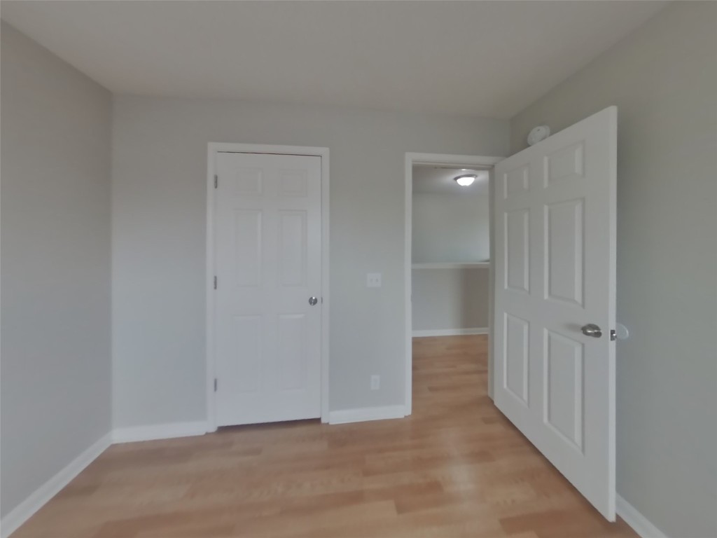 1027 Trail Driver Cove Georgetown, TX 78626 - Photo 9 of 17 Unfurnished bedroom featuring light wood-style floors and a closet