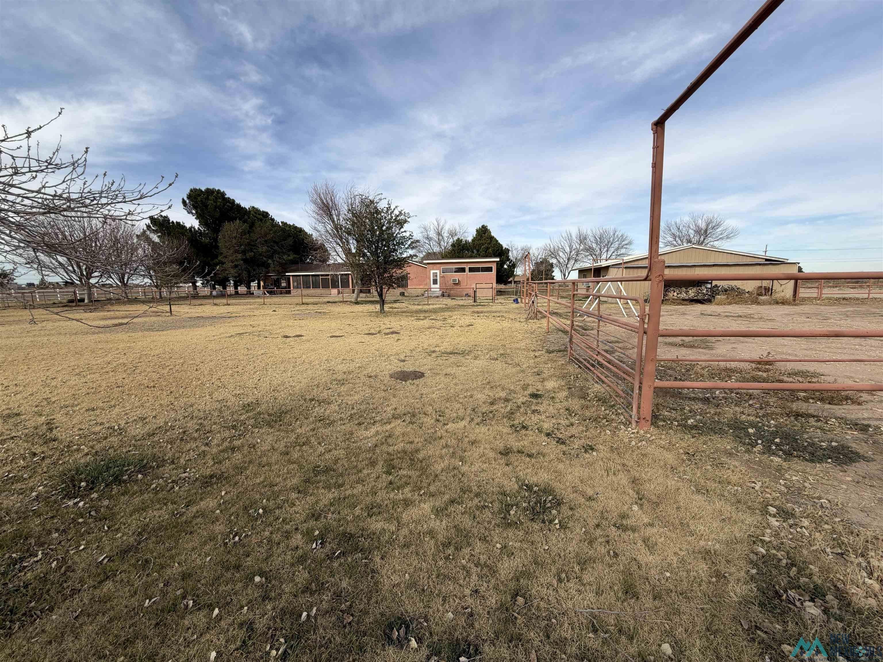 2001 East Derrick Road Carlsbad, NM 88220 - Photo 20 of 84 View of yard featuring a rural view, an outdoor structure, and an exterior structure