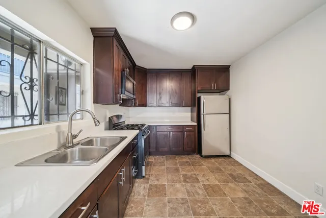 a kitchen with a sink cabinets and stainless steel appliances