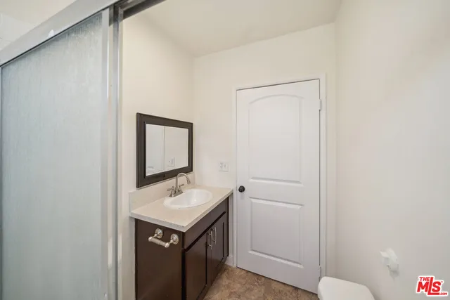 a bathroom with a sink a toilet and mirror
