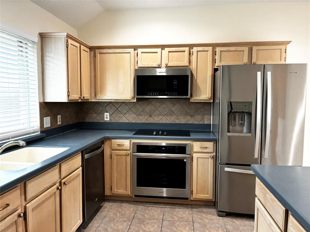 7936 Tournament Road Frisco, TX 75035 - Photo 11 of 28 a kitchen with a refrigerator stove and microwave