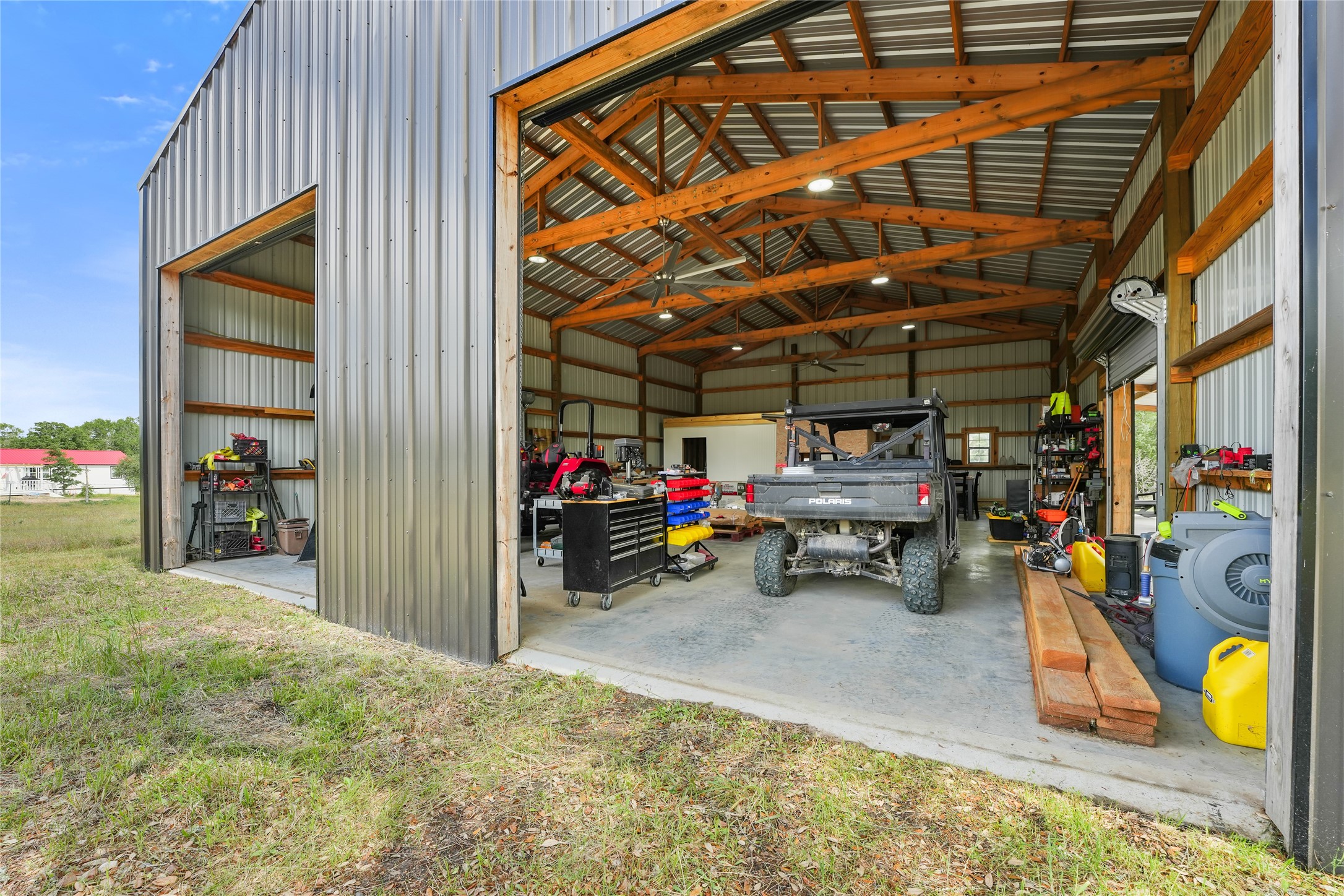 5837 FM 180 Road Ledbetter, TX 78946 - Photo 4 of 16 Spacious timber built barn. Construction Drawings in attachments of listing. 4 bay doors for ventilation and ease of getting equipment in and out. All non realty items excluded but negotiable.