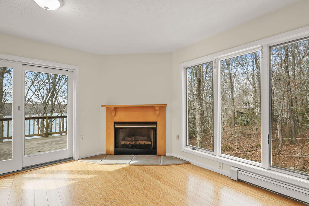 75 Edgewater Road Mashpee, MA 02649 - Photo 31 of 78 a view of an empty room with a fireplace and a window