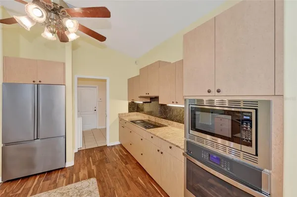 a kitchen with stainless steel appliances a stove a refrigerator and a microwave
