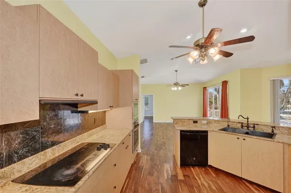 a kitchen with a sink appliances and a counter top