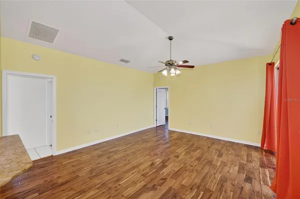 a view of a room with wooden floor and chandelier