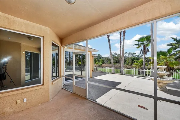 a swimming pool with outdoor seating and yard