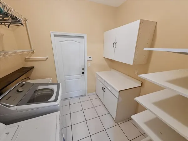 a utility room with sink dryer and washer