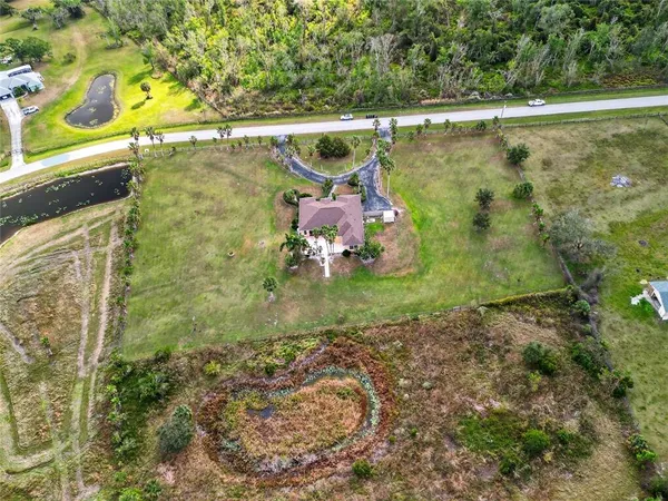 an aerial view of a house with a yard