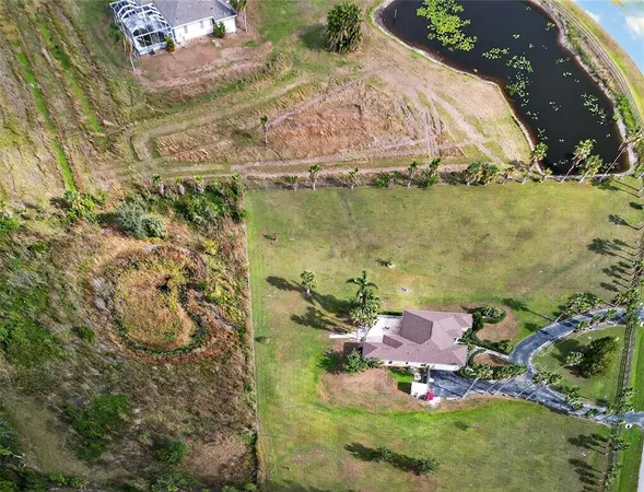 an aerial view of a house with a lake view