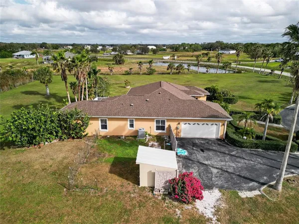 an aerial view of a house with big yard