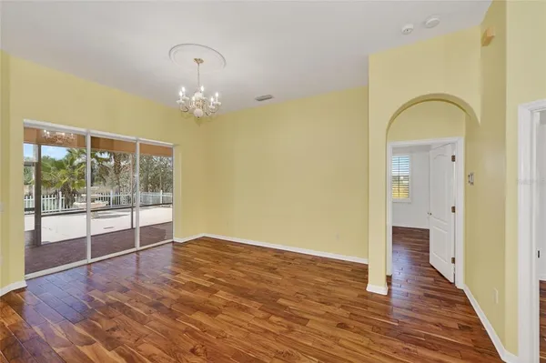 a view of a room with wooden floor and sliding door