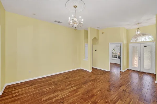 a view of livingroom with hallway and wooden floor
