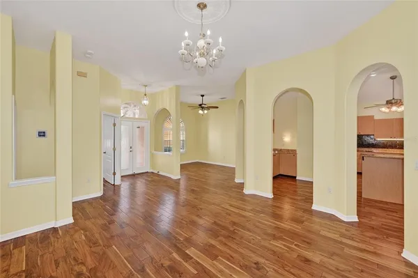 a view of a hallway with wooden floor and staircase
