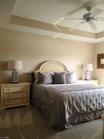 a bedroom with a bed and a lamp