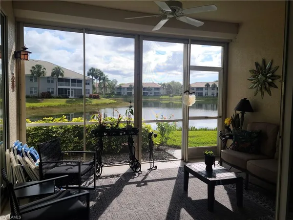 a view of a living room with furniture and floor to ceiling window