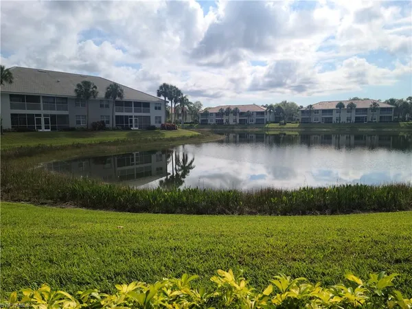 a view of a lake with a house in the background