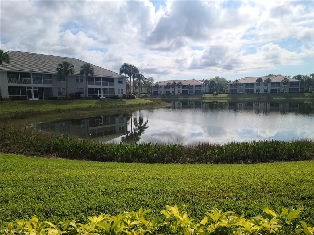 2255 Harmony Lane, Unit 8 Naples, FL 34109 - Photo 17 of 19 a view of a lake with a house in the background