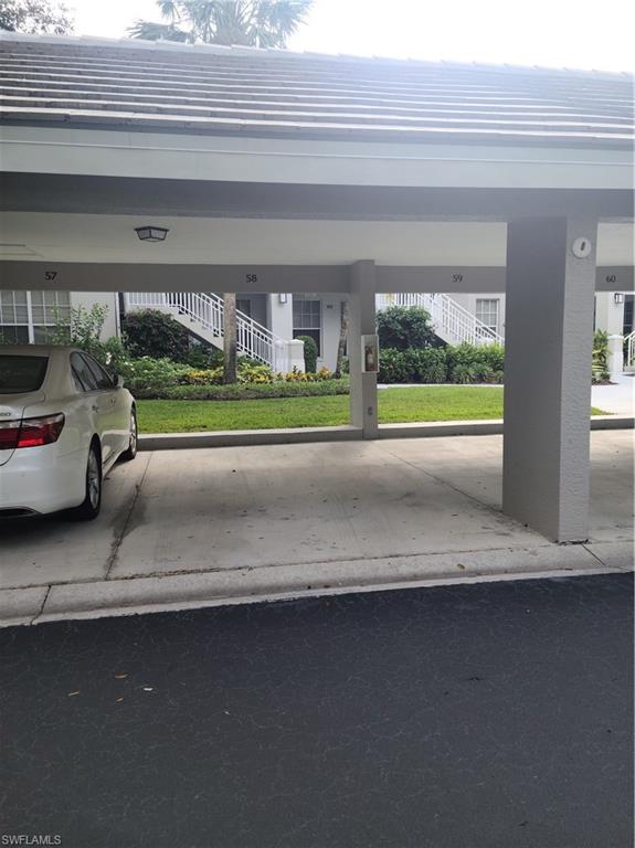 2255 Harmony Lane, Unit 8 Naples, FL 34109 - Photo 18 of 19 a view of a car park from a window