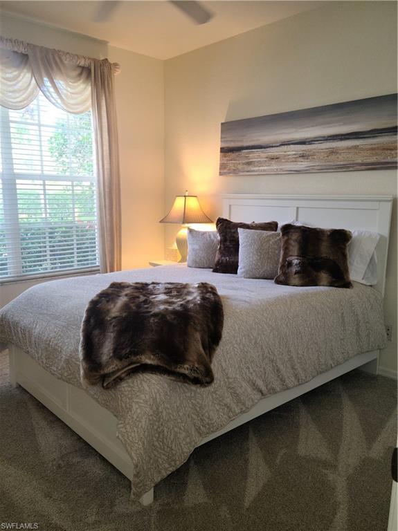 2255 Harmony Lane, Unit 8 Naples, FL 34109 - Photo 8 of 19 a bedroom with a bed and a large window