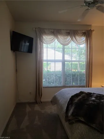 a bedroom with a bed and a television