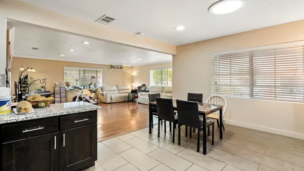 a kitchen with counter space dining table and chairs