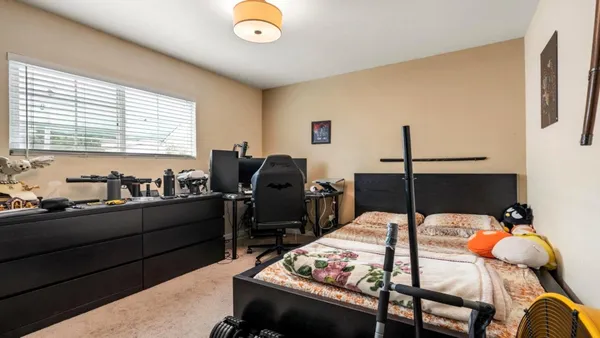 a bed room with furniture and two window