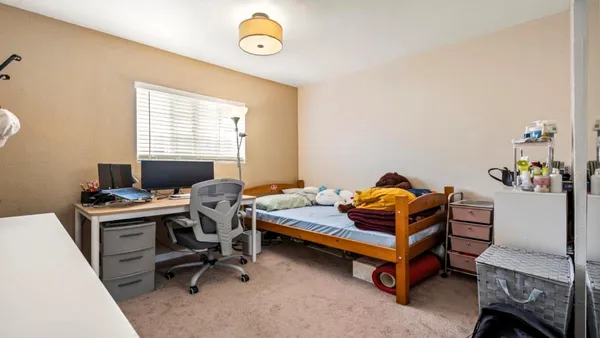 a bedroom with a workspace