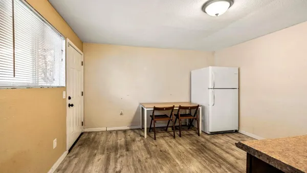 a view of kitchen with furniture and wooden floor