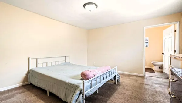 a bedroom with a bed and a table