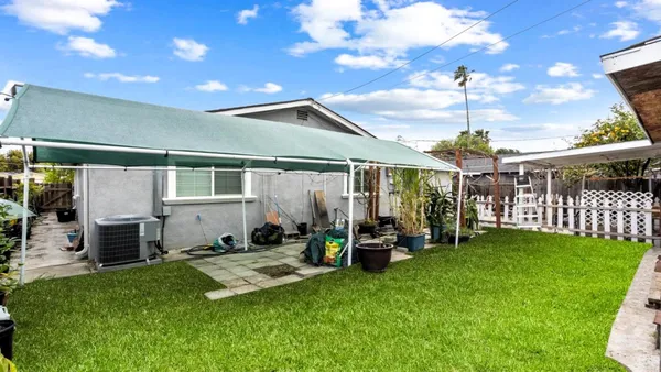 a view of a house with backyard and porch
