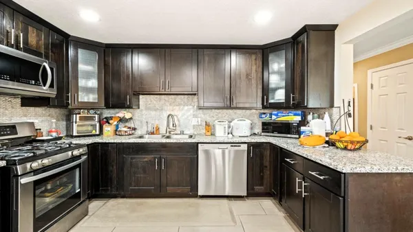 a kitchen with stainless steel appliances granite countertop a sink stove and cabinets