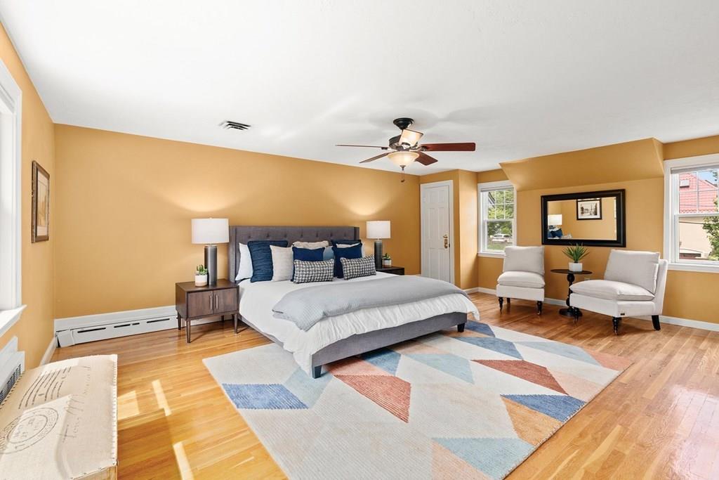 7 Dorothy Road Newton, MA 02459 - Photo 14 of 23 a spacious bedroom with a bed a couch and a potted plant